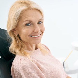 a patient smiling with her new dental implants