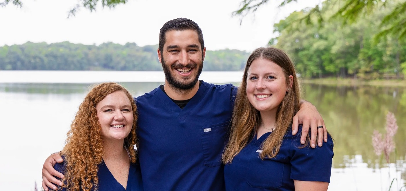 Smiling dentist and two team members at Samia Family Dentistry in Garner