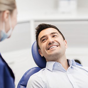 Patient smiling at dentist during exam