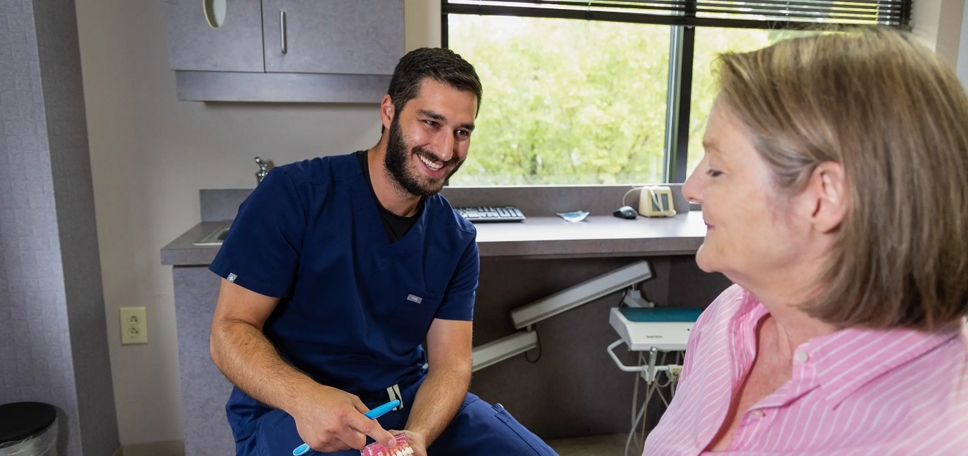 Dentist talking to a patient about full mouth rehabilitation in Garner