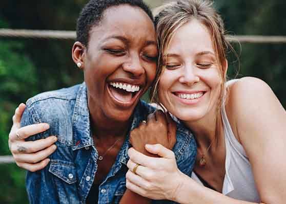 Patient in Garner with dental implants smiling with a friend