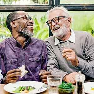 Older patient with dental implants socializing