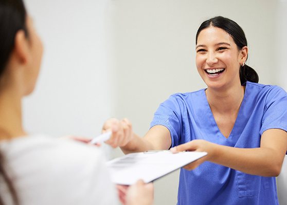 Woman handing a dentist paperwork