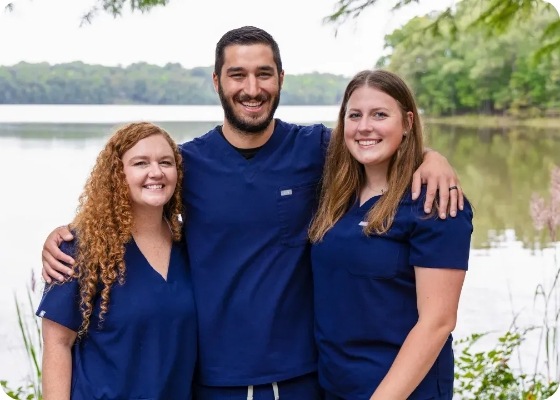 Childrens dentist in Garner smiling outdoors with two dental team members