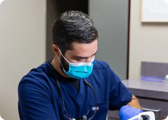 Doctor Samia wearing a face mask while treating a dental patient